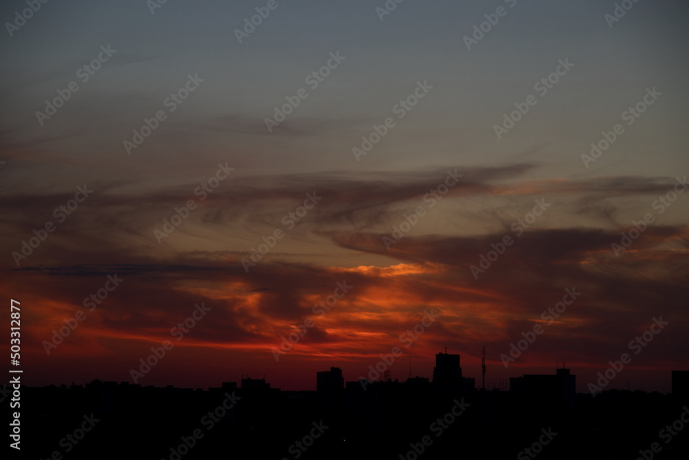 Dramatic sunset sky with clouds over the city Dramatic sunset sky with clouds over the city
