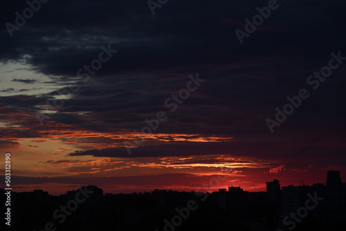 Dramatic sunset sky with clouds over the city