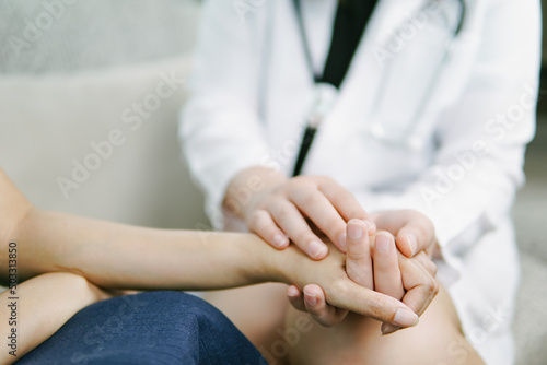Doctor holding hands to comfort patient, doctor encouraging support and comforting with sympathy. 