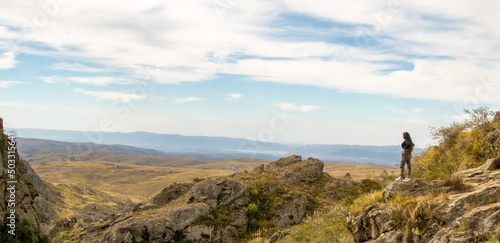 Horizontal view of unrecognizable backpacker sightseeing in Zumaia cliffs. Horizontal panoramic view of man traveling in vasque country. People and travel destination in Spain