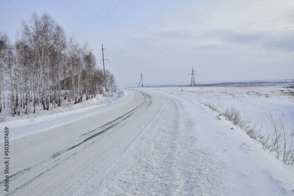 Snow covered dirt road in winter, Russia
