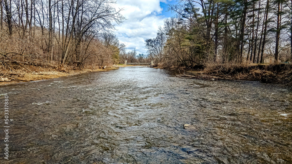 Over the open water during spring with the bridge down the river Over the open water during spring with the bridge down the river