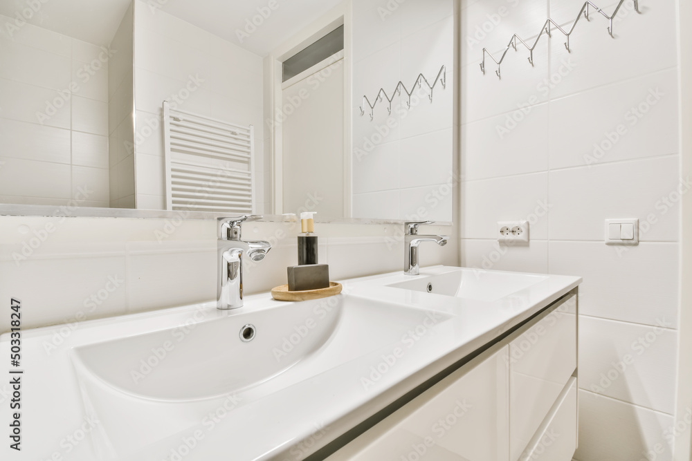 Minimalist bathroom with chrome taps and ceramic sinks Minimalist bathroom with chrome taps and ceramic sinks