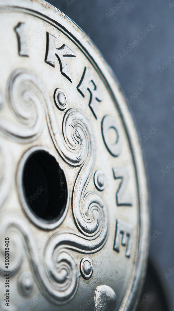 1 Danish krone coin close up. National currency of Denmark. Money illustration for news about economy or finance. Banking and credit. Wages and taxes. Vertical stories. Macro 1 Danish krone coin close up. National currency of Denmark. Money illustration for news about economy or finance. Banking and credit. Wages and taxes. Vertical stories. Macro