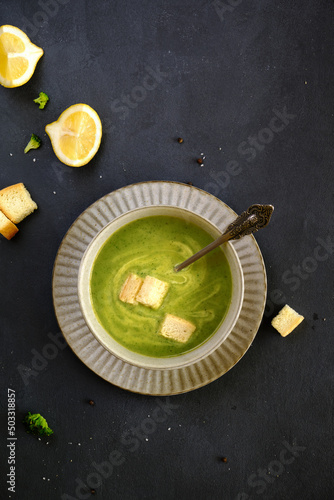 Tasty and healthy dietary food. Broccoli soup cream on a black background