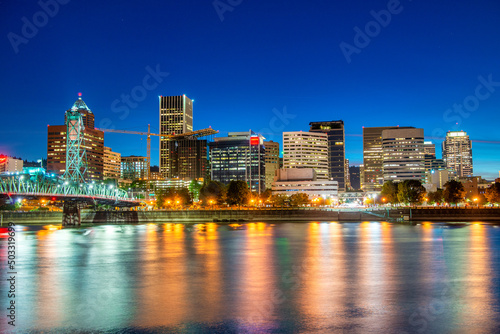 PORTLAND, OR - AUGUST 18, 2017: City buildlngs at night with river reflections of lights.