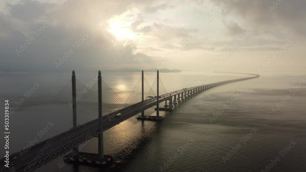 Aerial fly away Penang Second Bridge in morning sun ray Aerial fly away Penang Second Bridge in morning sun ray