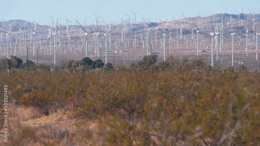 Windmills turbine rotating, wind farm or power plant, alternative green renewable energy generators, industrial field in California, Mojave desert, Tehachapi, USA. Electricity generation on windfarm. Windmills turbine rotating, wind farm or power plant, alternative green renewable energy generators, industrial field in California, Mojave desert, Tehachapi, USA. Electricity generation on windfarm.