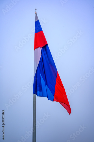 Slovenian flag against the blue sky