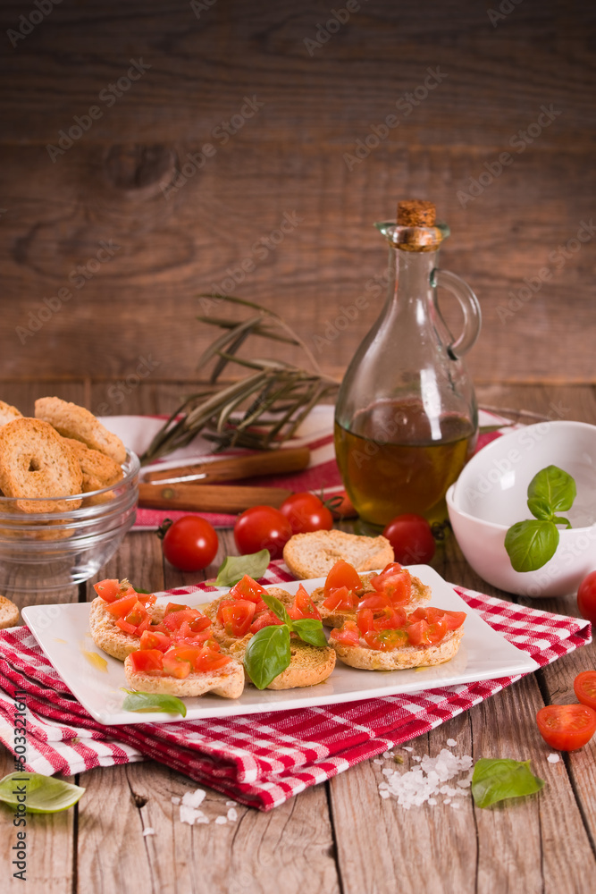 Friselle with cherry tomatoes and basil. Friselle with cherry tomatoes and basil.