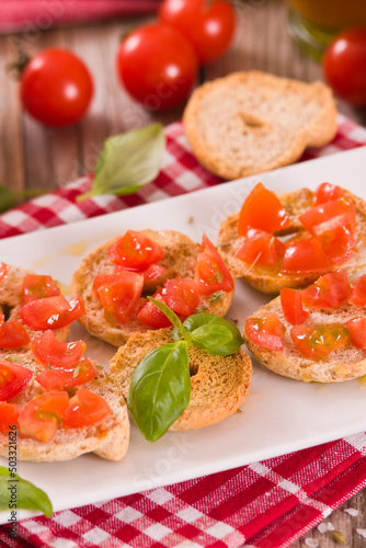Friselle with cherry tomatoes and basil.