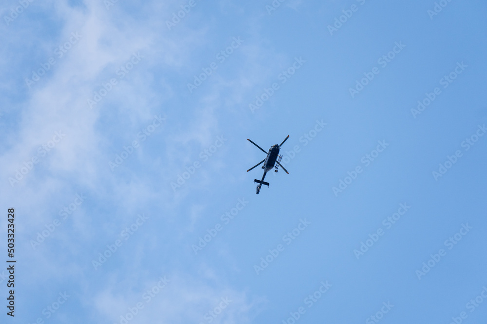 Flying police helicopter with blue sky Flying police helicopter with blue sky