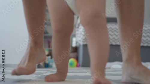 baby first steps with mom bottom view legs