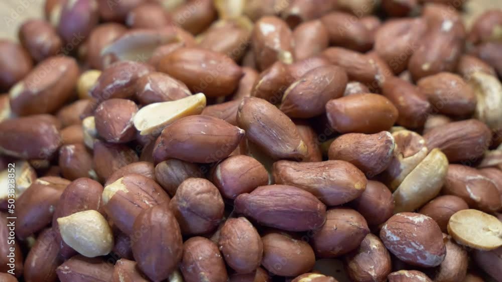 Roasted peanuts in the peel. Peanuts close-up. Highly detailed macro video. Peanuts full frame image, rotation. Roasted peanuts in the peel. Peanuts close-up. Highly detailed macro video. Peanuts full frame image, rotation.