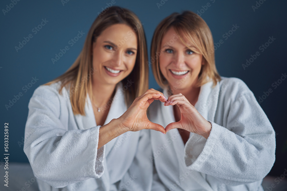 Two girls wearing bathrobe in spa or hotel having fun Two girls wearing bathrobe in spa or hotel having fun