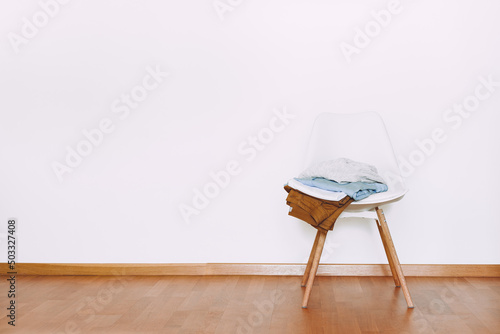 Indoors flat wall mockup with Clothes on Chair