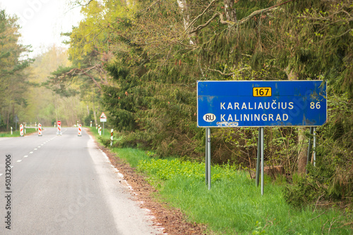State border between Lithuania and the Russian enclave of Kaliningrad in Russia closed due to sanctions imposed by the European Union with stop sign on the empty road photo