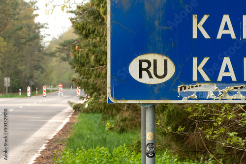 State border between Lithuania and the Russian enclave of Kaliningrad in Russia closed due to sanctions imposed by the European Union with stop sign on the empty road photo