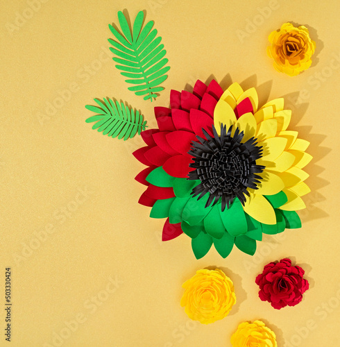 Creative background for Juneteenth African American Holiday. Handcraft flower in Pan-African colours