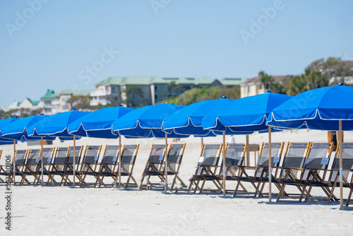 Row of beach chairs and umbrellas on the beach © chrt2hrt