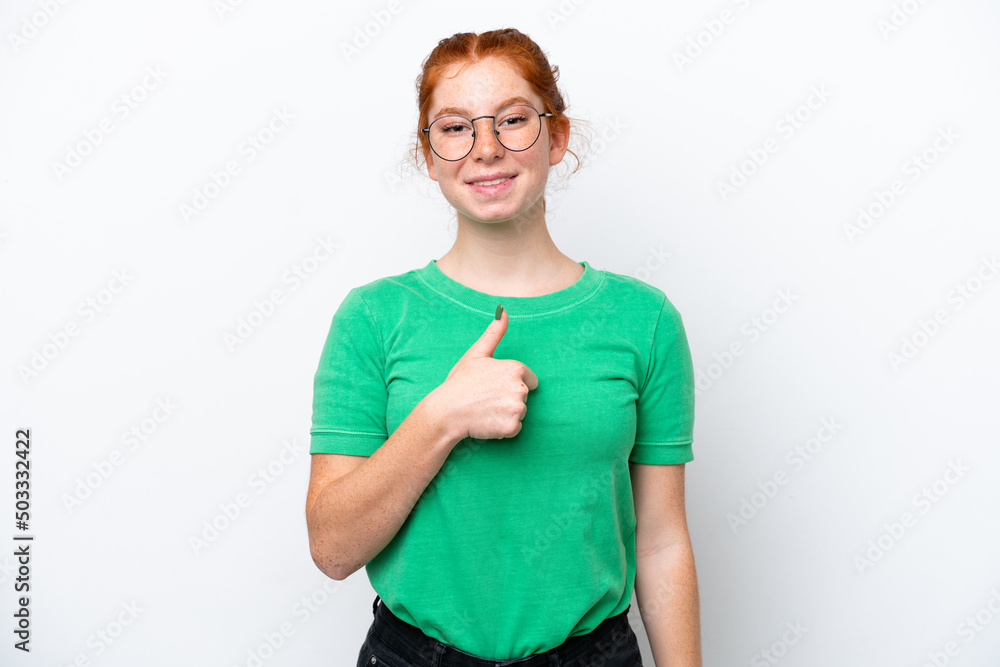 Young reddish woman isolated on white background giving a thumbs up gesture Young reddish woman isolated on white background giving a thumbs up gesture