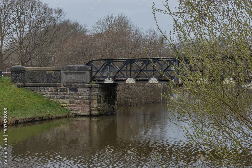 Black and white iron bridge spanning a river Black and white iron bridge spanning a river