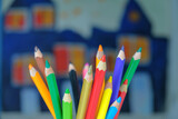 Different colors drawing pencils on a blurred painted background