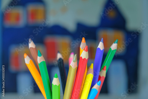 Different colors drawing pencils on a blurred painted background