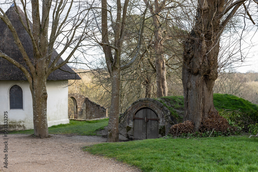 Round white building next to a under gound bunker