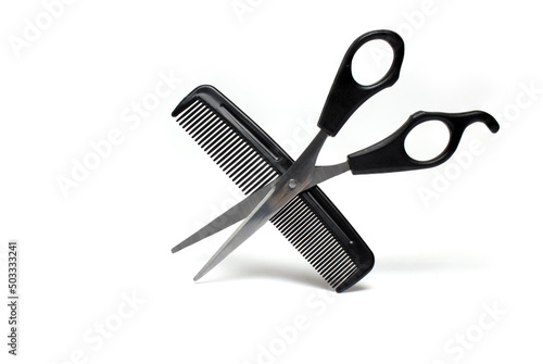 Closeup hair scissors crossed comb white background