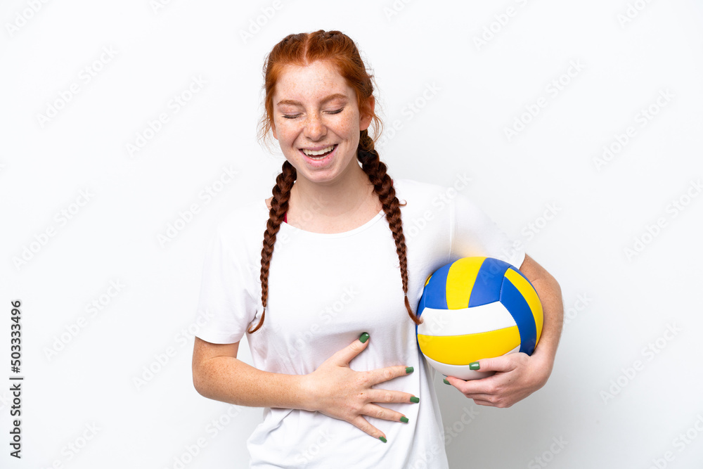 Young caucasian reddish woman playing volleyball isolated on white background smiling a lot