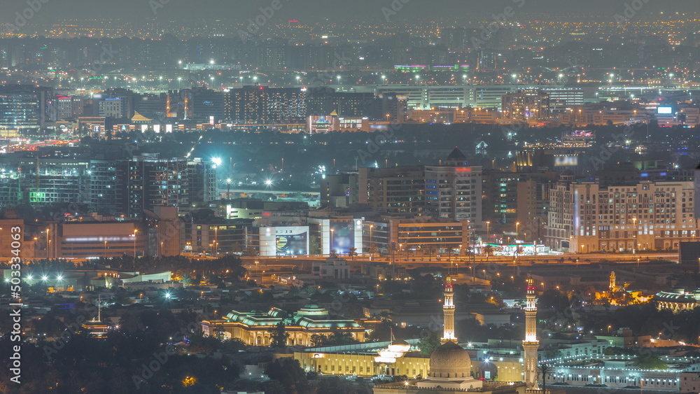 Aerial view of Bur Dubai, the Creek, Deira district and Sharjah night timelapse