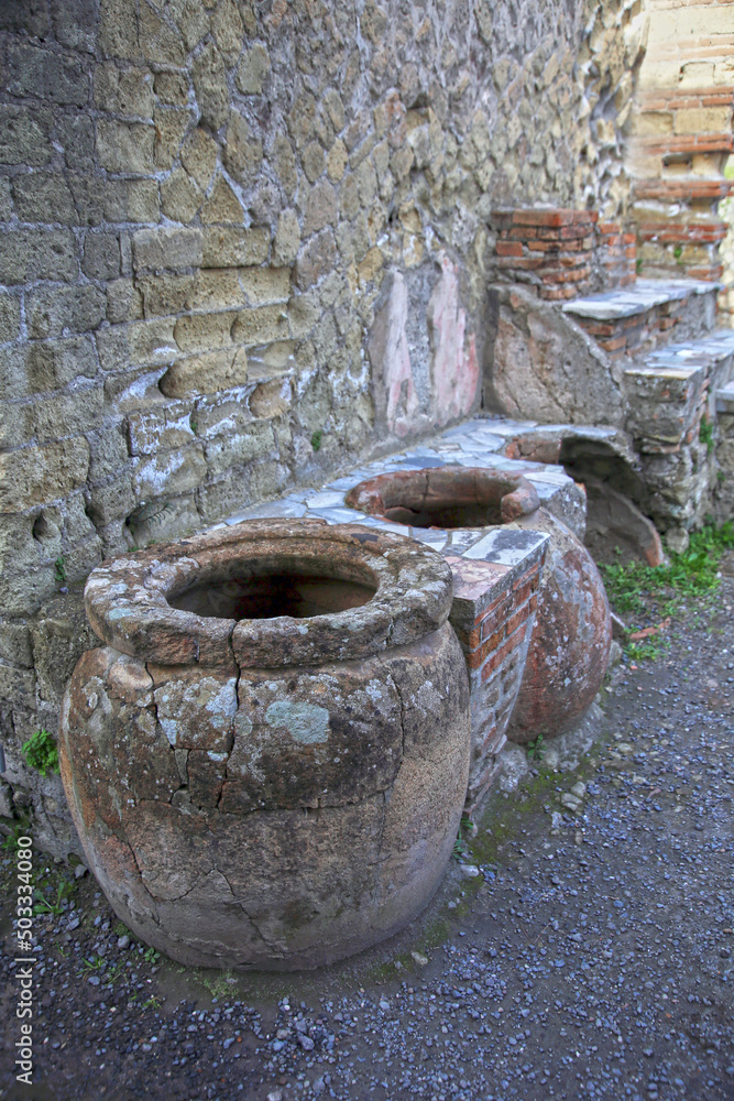 Ruined remains of an ancient Roman tavern, with exposed jars, Herculaneum, Campania, Italy Ruined remains of an ancient Roman tavern, with exposed jars, Herculaneum, Campania, Italy