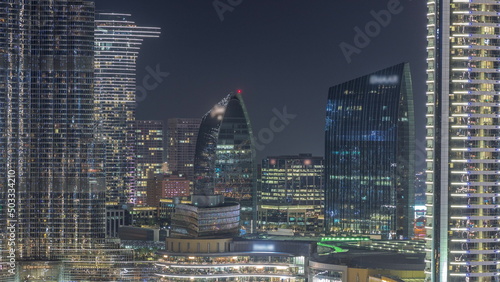 Shopping mall exterior with reataurants near fountain in Dubai downtown aerial night timelapse, United Arab Emirates photo