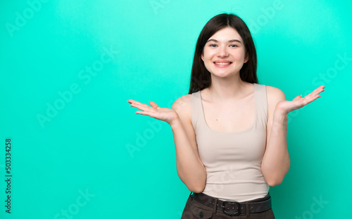 Young Russian woman isolated on green background with shocked facial expression