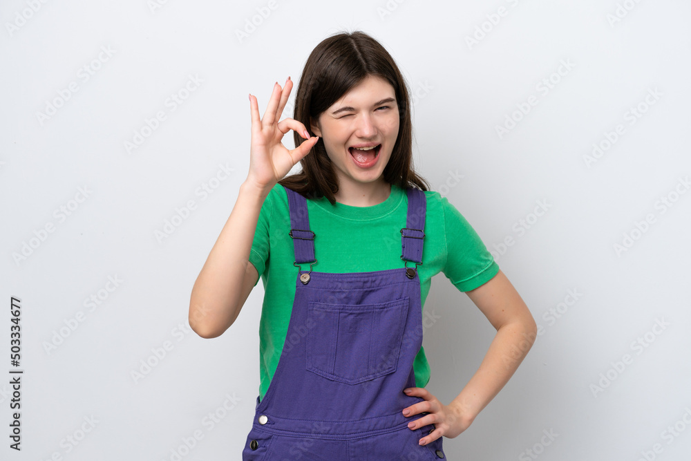 Young Russian woman isolated on blue background showing ok sign with fingers Young Russian woman isolated on blue background showing ok sign with fingers