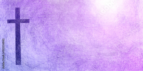 dark cross on purple to pink textured sun background with copy space