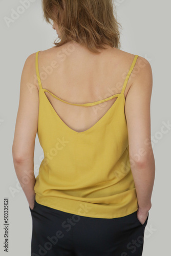 Close up portrait of Caucasian woman in yellow linen camisole shirt