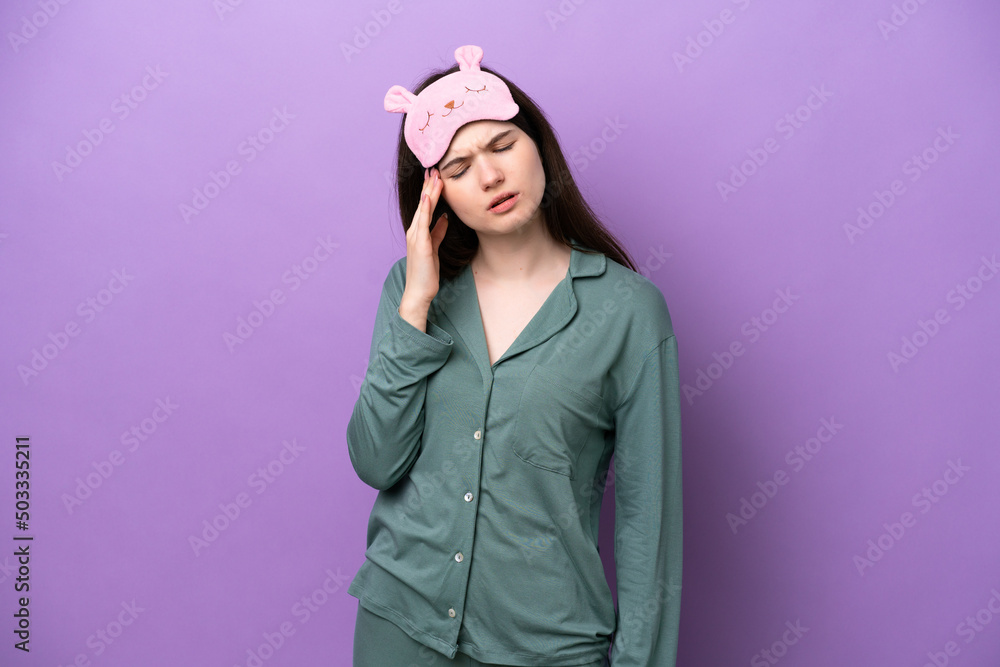 Young Russian woman in pajamas isolated on purple background with headache Young Russian woman in pajamas isolated on purple background with headache