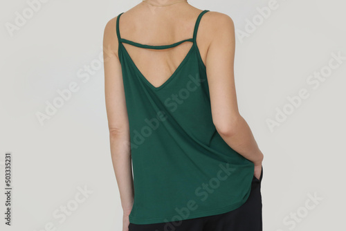 Fototapeta Woman in green cotton camisole shirt, studio shot.