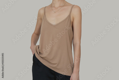 Fotografia, Obraz Woman in beige cotton camisole shirt, studio shot.