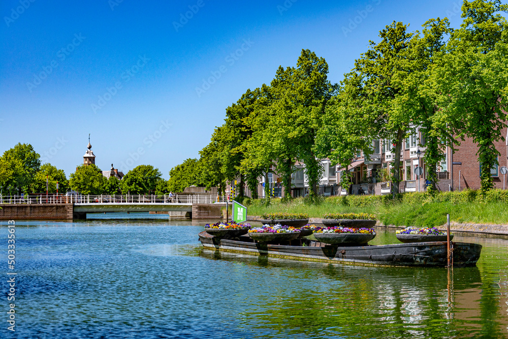 Beautiful tranquil view of a green blue water canal in a bright sunny summer day Beautiful tranquil view of a green blue water canal in a bright sunny summer day