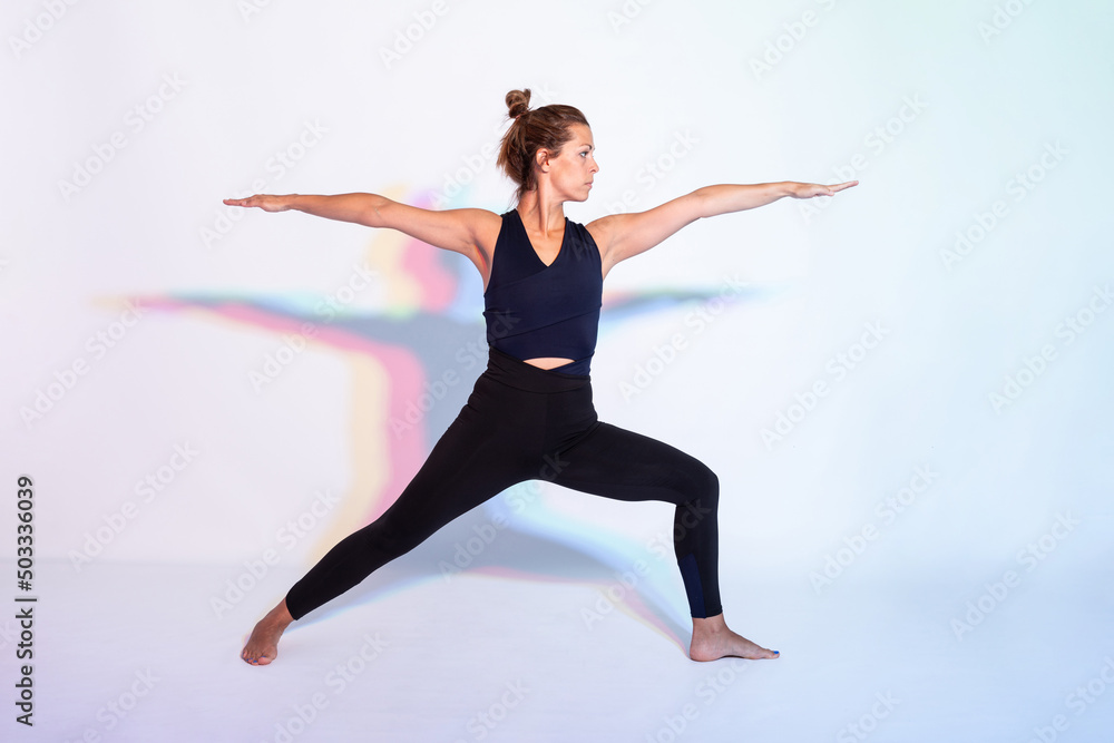 Woman performing Warrior II asana Woman performing Warrior II asana