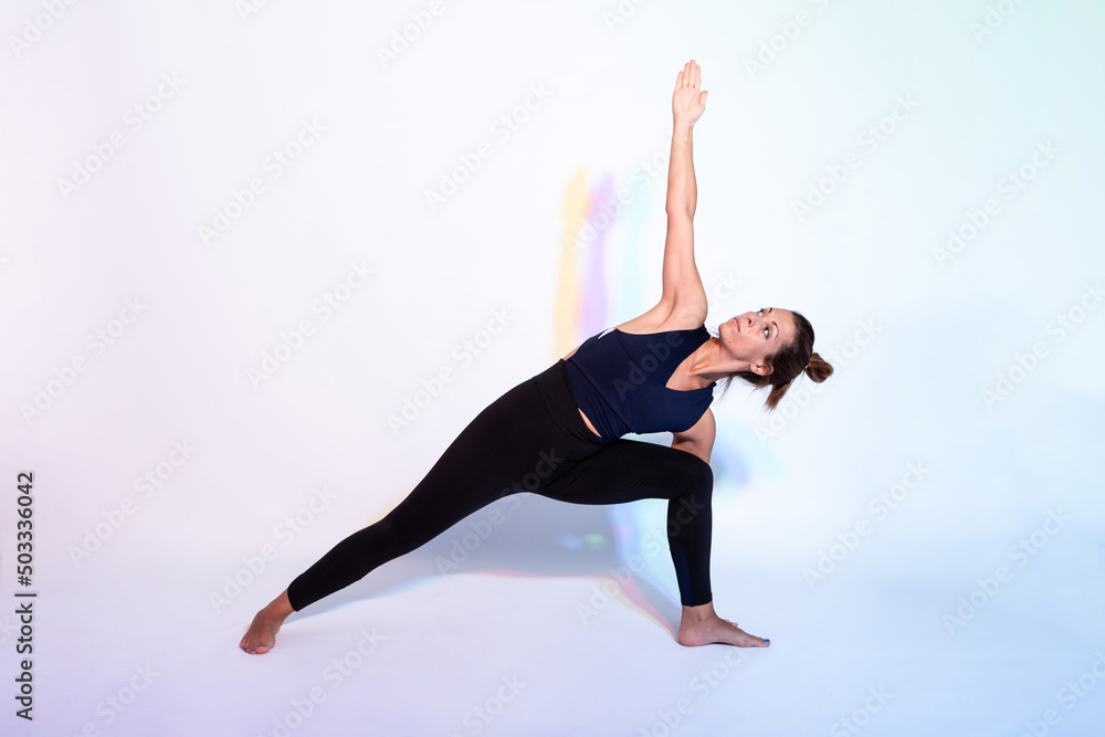 Active woman doing Side angle asana Active woman doing Side angle asana