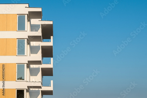 Modern apartment building under construction. Sunny day with blue sky.