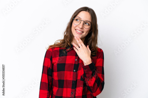 Young caucasian woman isolated on white background looking up while smiling © luismolinero