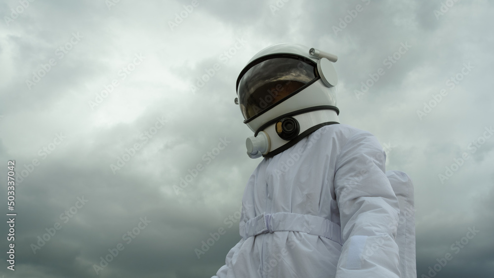 An astronaut explores an unknown planet. Heavy cloudy sky. An astronaut explores an unknown planet. Heavy cloudy sky.