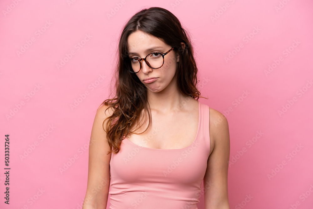Young caucasian woman isolated on pink background with sad expression Young caucasian woman isolated on pink background with sad expression