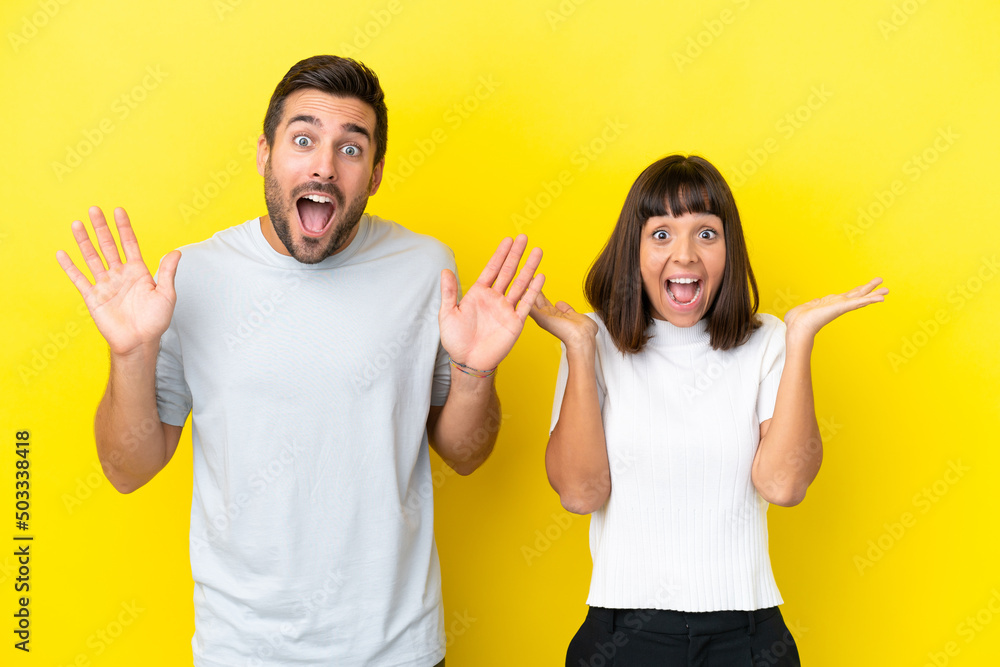Young couple isolated on yellow background with surprise and shocked facial expression Young couple isolated on yellow background with surprise and shocked facial expression