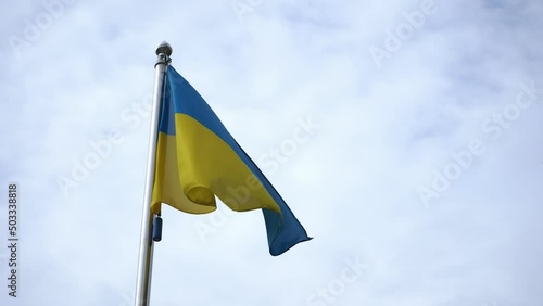 The flag of Ukraine flutters in the wind against the sky